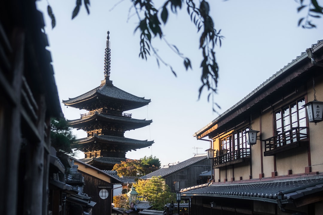 A narrow street with a pagoda in the background