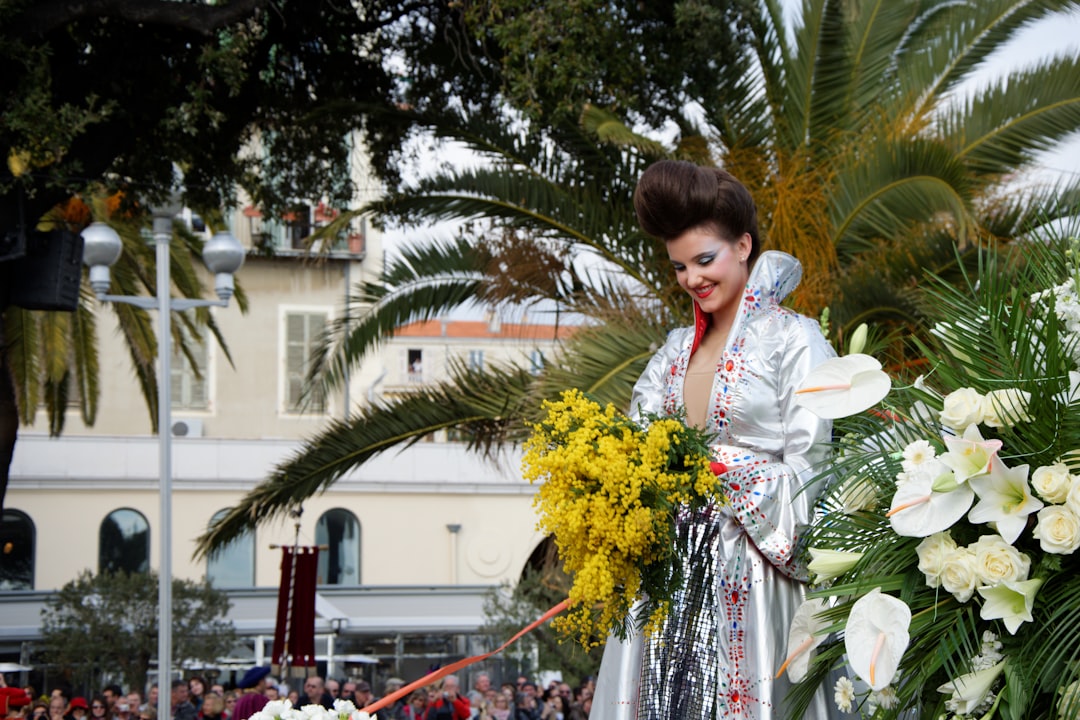 Woman in costume holding yellow flowers on float