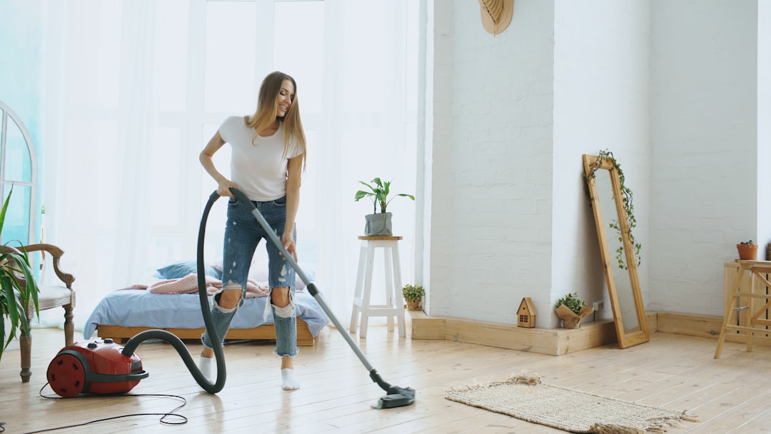 A woman vacuuming a bright, modern living room